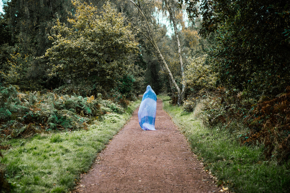 woman walking path with head covered