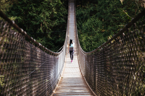 woman walks bridge