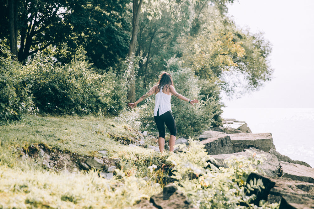 woman walks down to waters edge