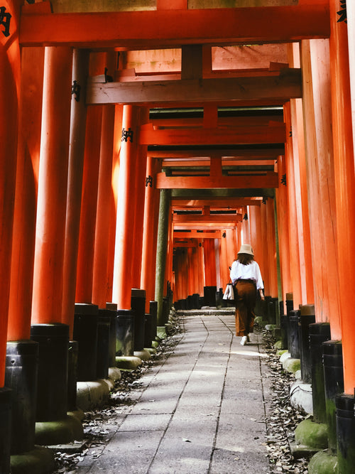 woman walks up a historical japanese path