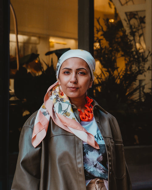 woman wearing headscarf looks into lens
