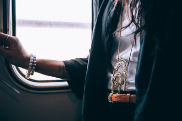 woman wearing necklace on train