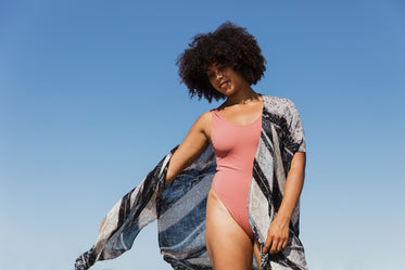 woman wearing pink bathing suit and flowing kaftan