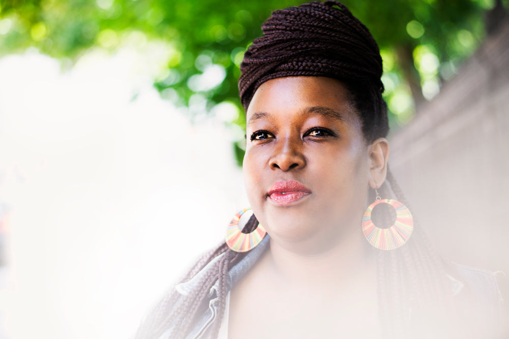 woman with braids looks off to horizon