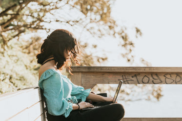 woman with hair over face works on her laptop