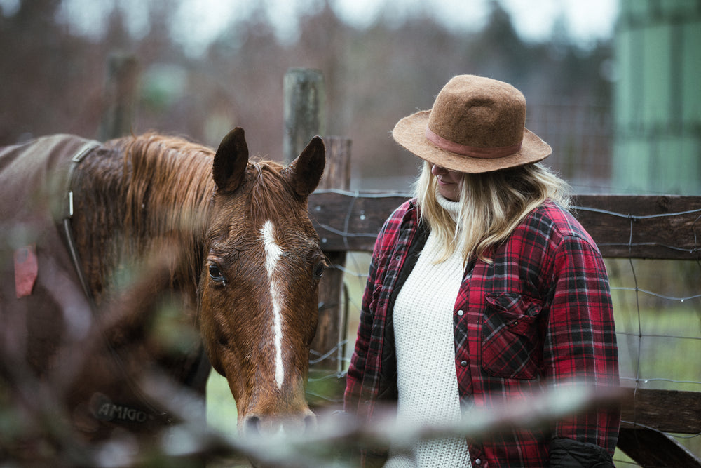 woman with horse in corral