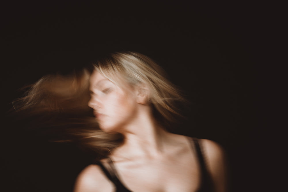 woman with long blond hair in motion blur