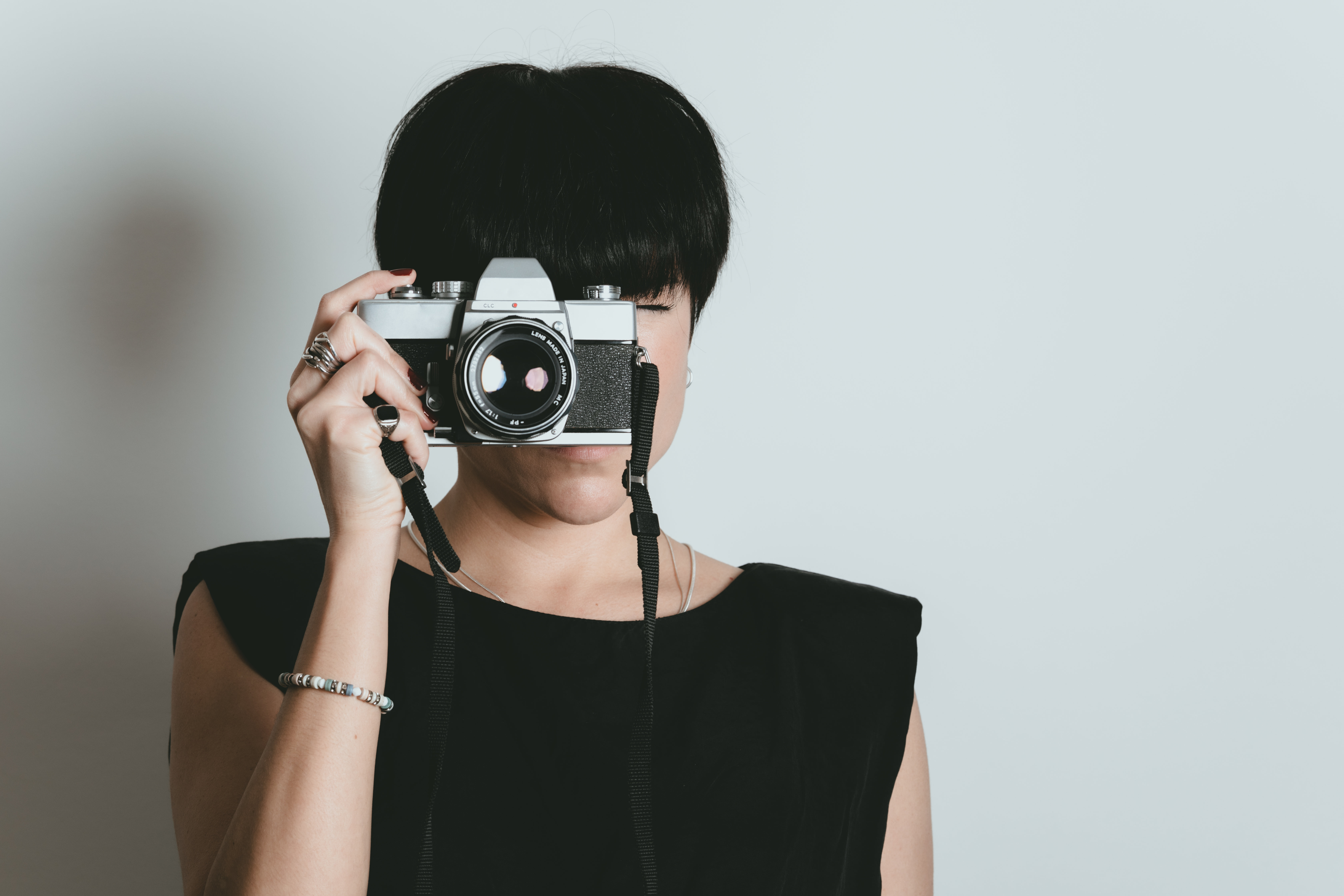 Woman WIth Short Dark Hair Takes A Photo