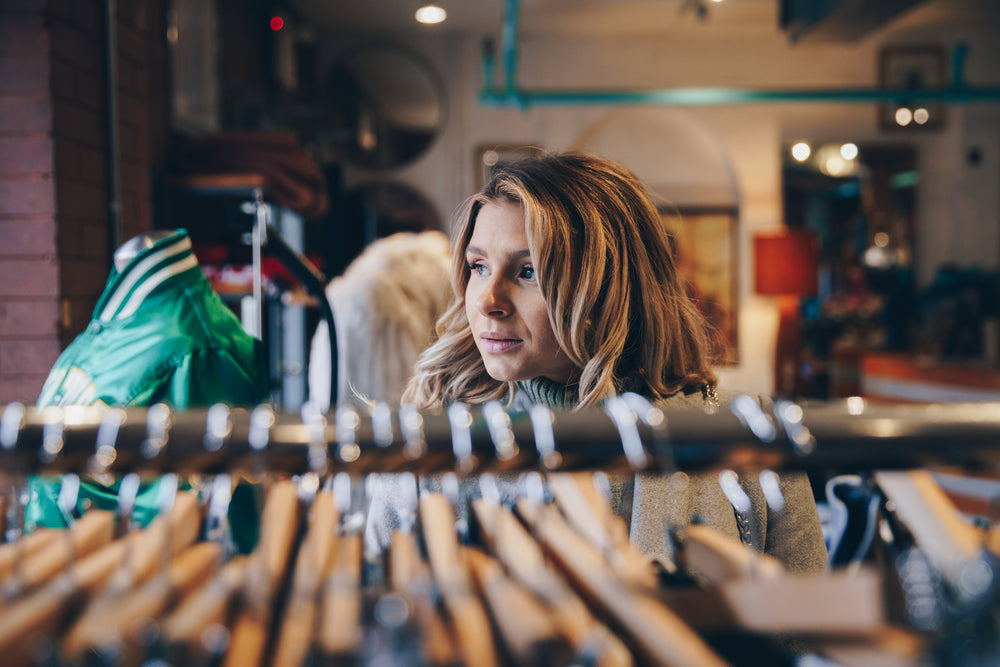 woman within clothing racks