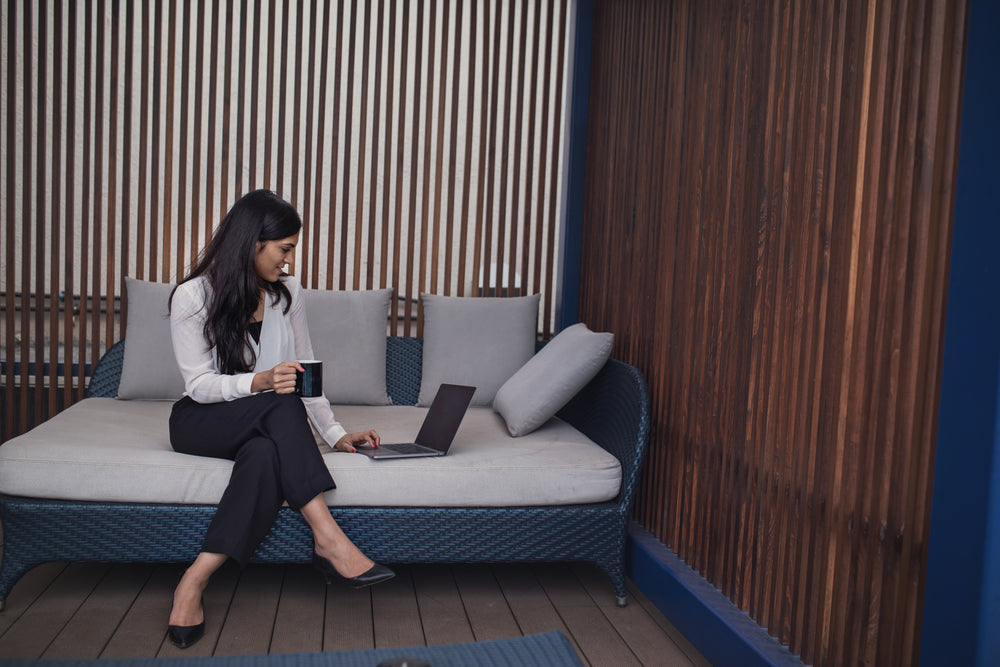 woman working on laptop on patio