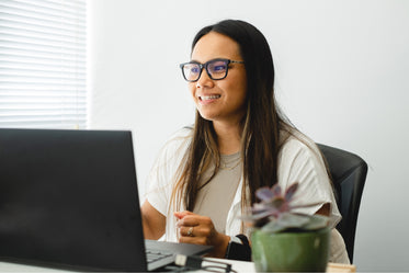 woman works at her desk with a laptop