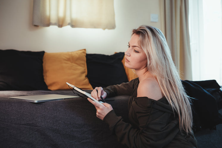 Woman Writes In A Open Journal As Wellness Practice