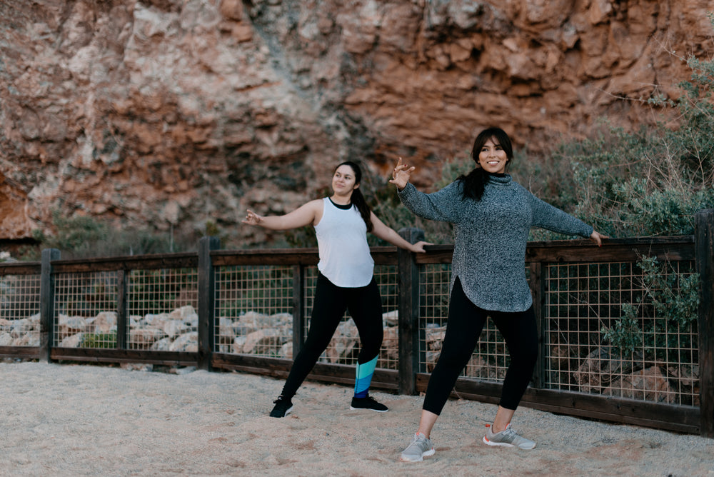 women exercising on the sand