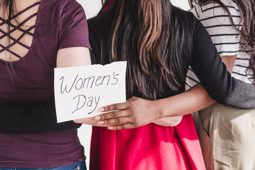 women linking arms in celebration of women's day