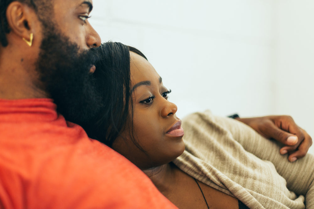 women rests her head on a mans shoulder