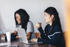 women sat during a meeting while enjoying a coffee
