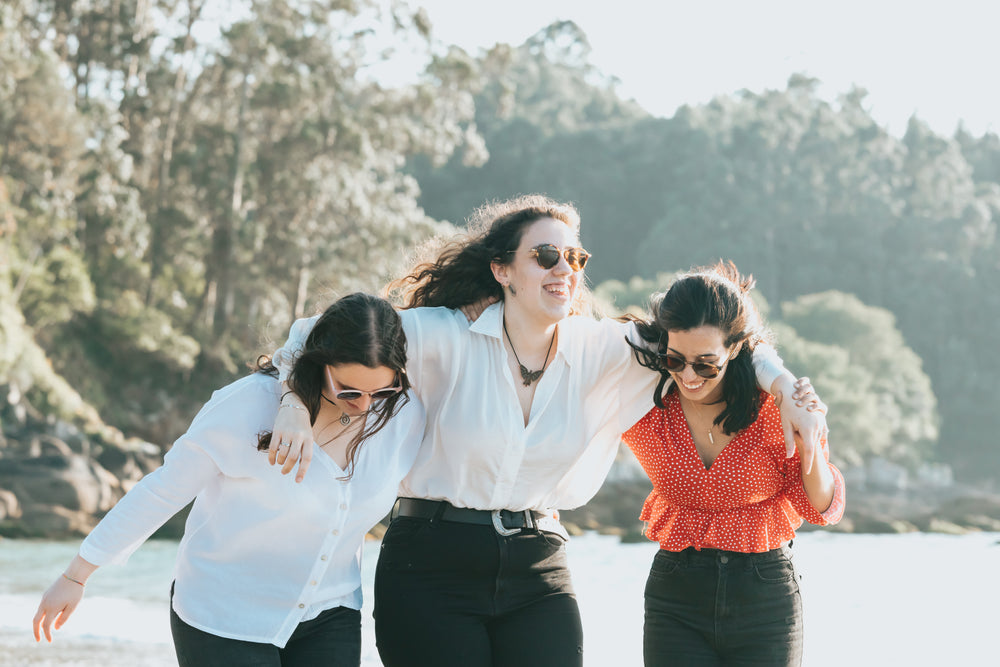 women walk with their arms around each other