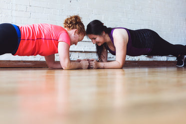 women who plank together