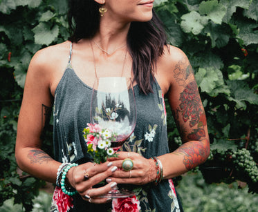 women's fashion tattooed woman stood in vineyard