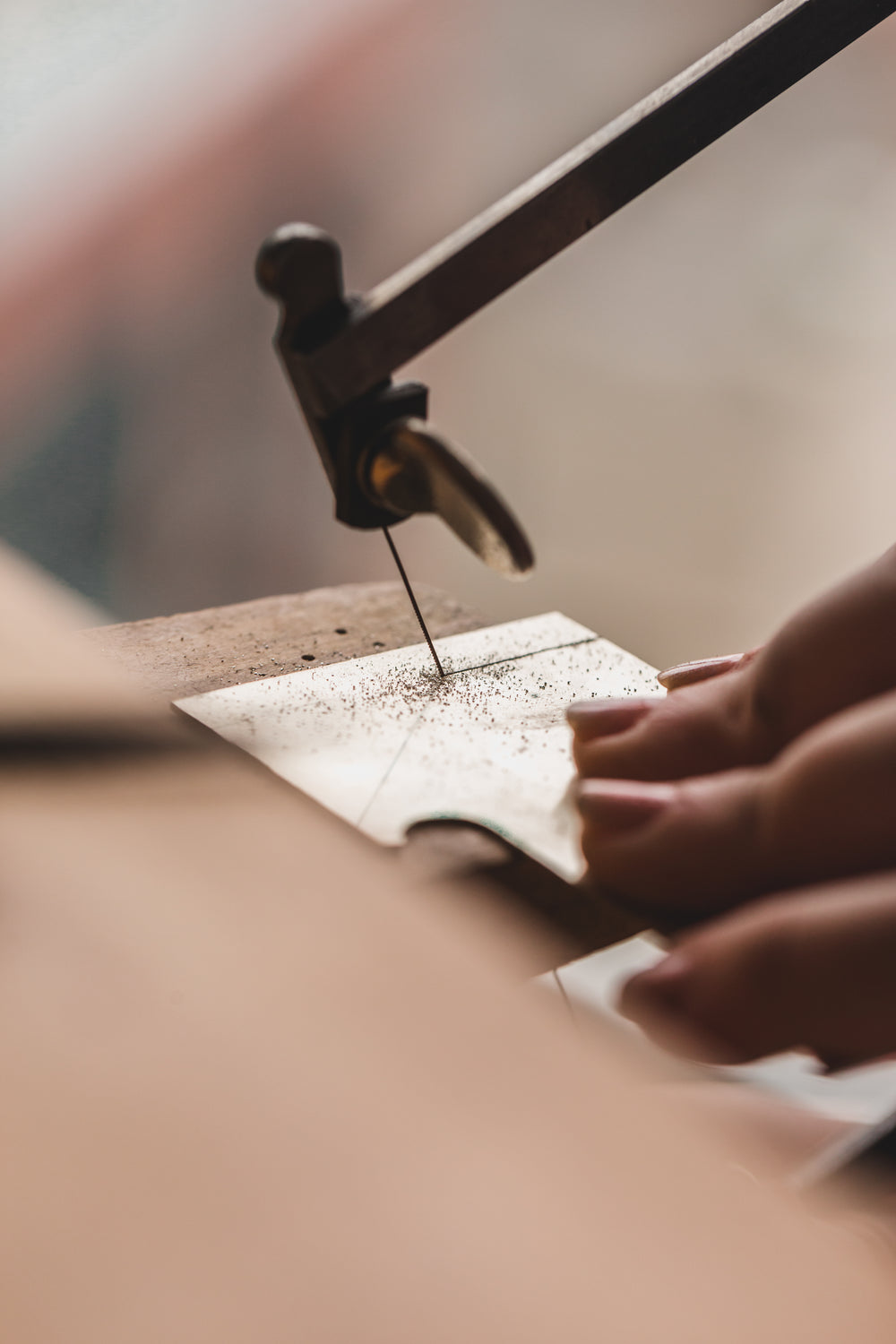 womens hand sawing through metal