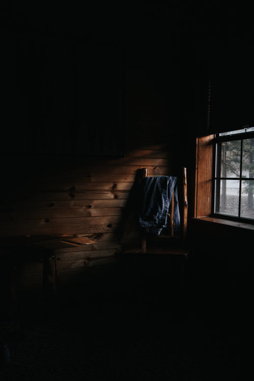wood cabin wall light by window light