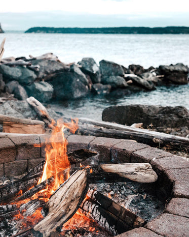 wood fire on a cold day by the water