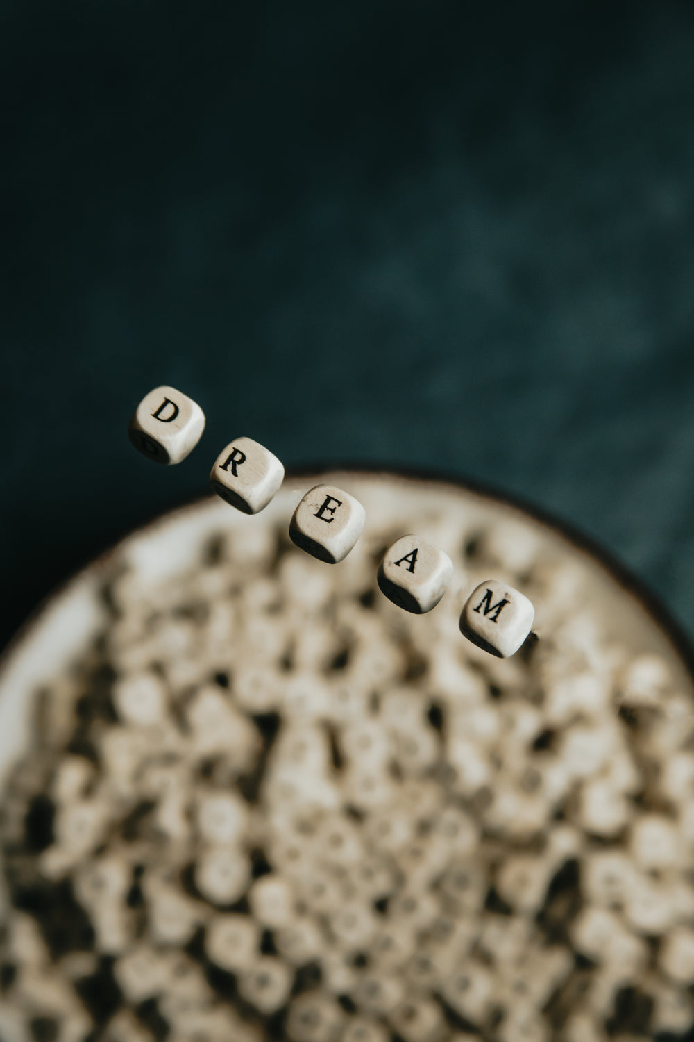 wooden beads float and spell out dream