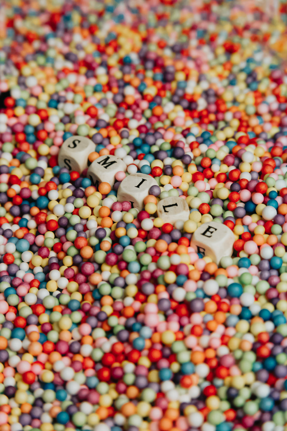 wooden blocks lay in colorful dots and spell smile