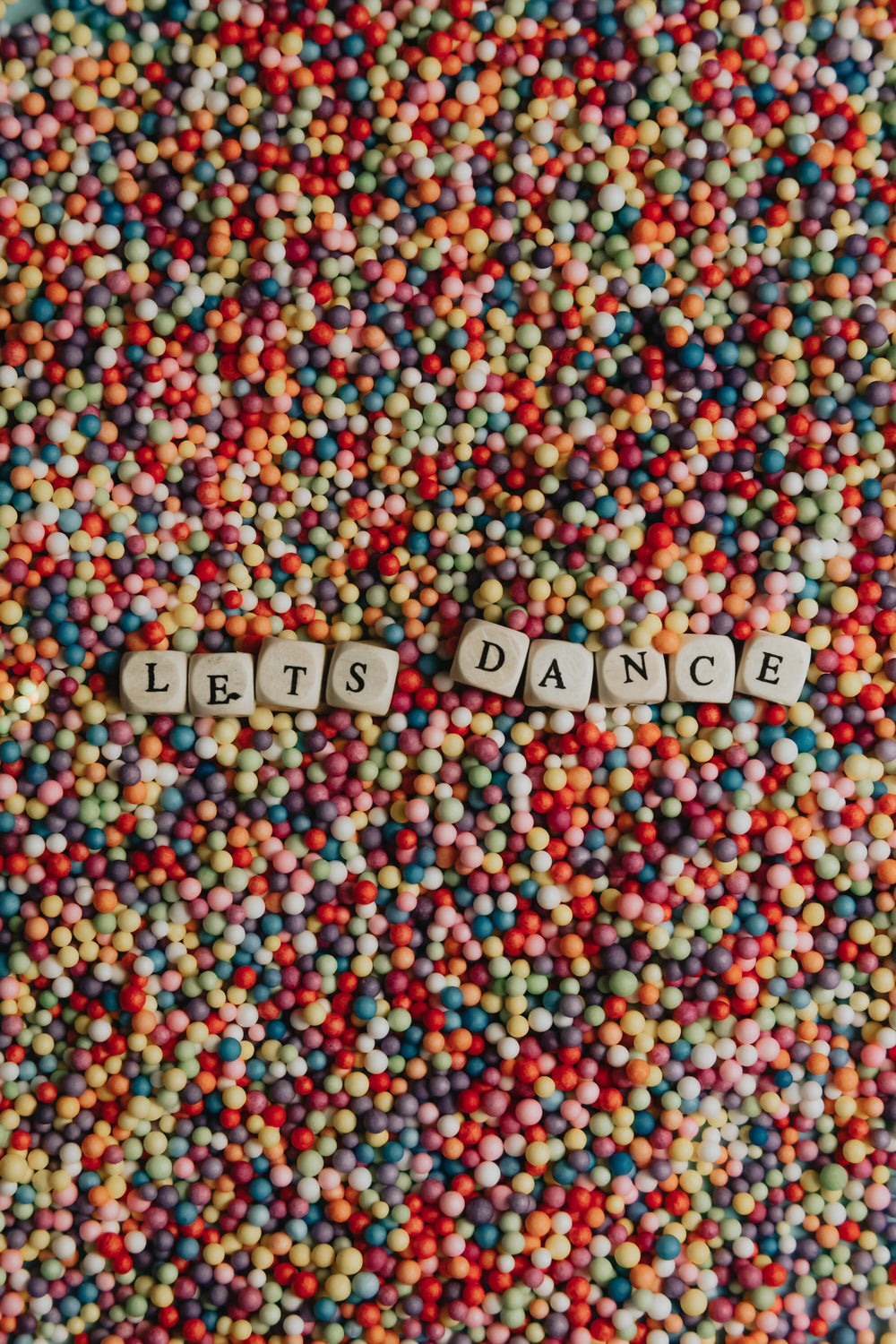 wooden blocks with black letters spell lets dance