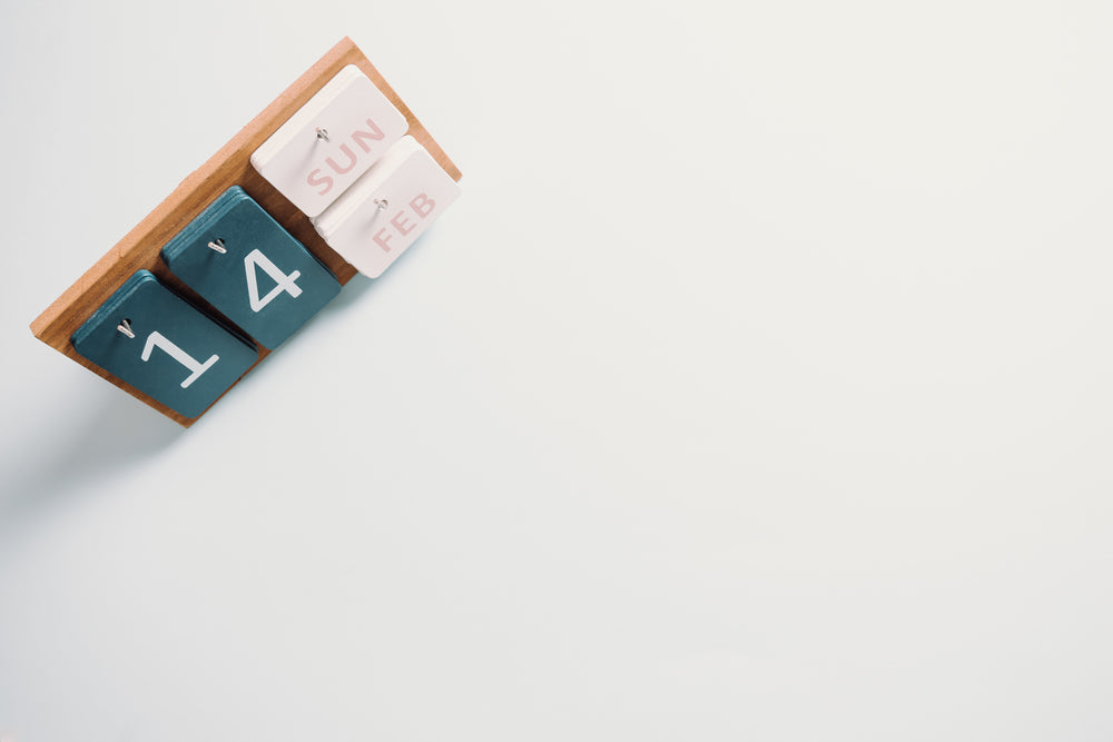 wooden calendar sits on a white background