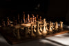 wooden chess set in partial window light