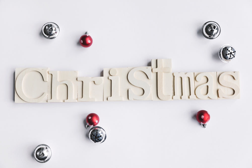 wooden christmas sign with bells and baubles