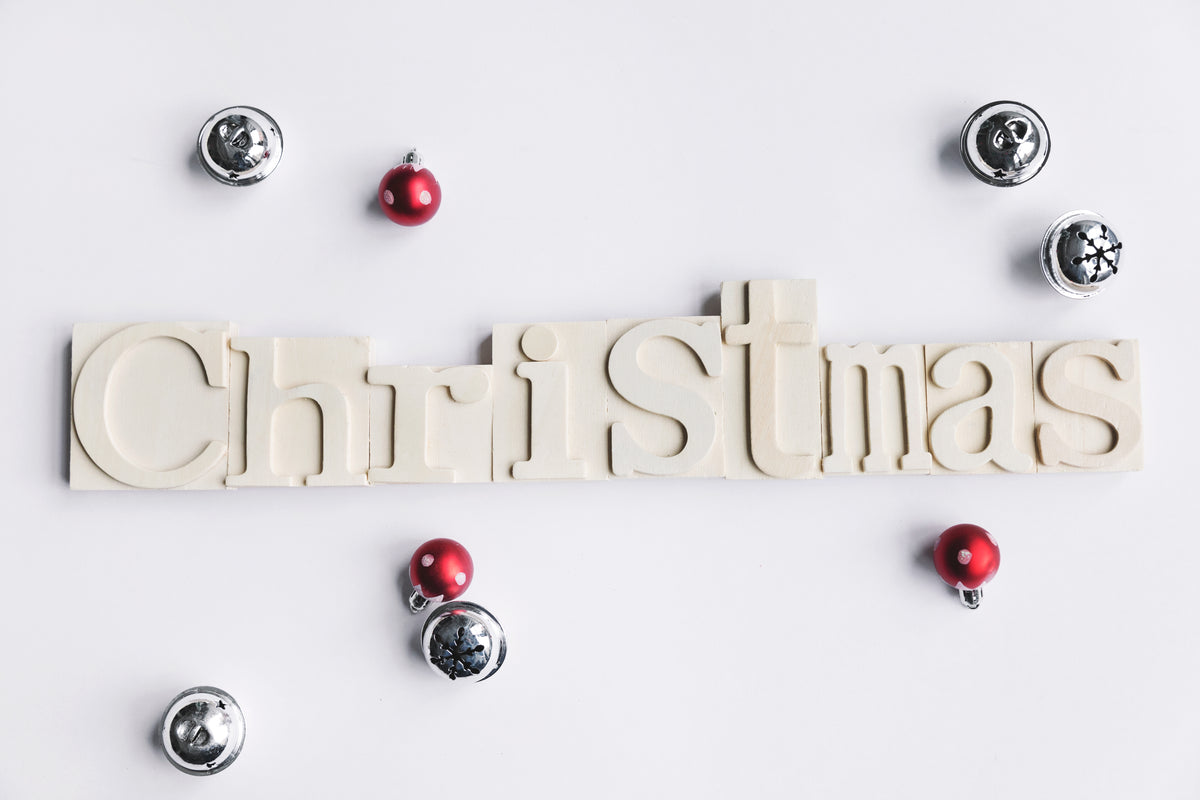 wooden christmas sign with bells and baubles