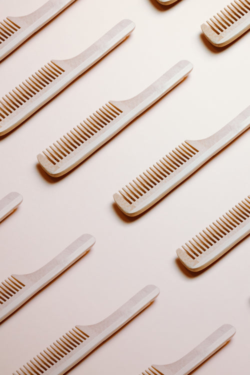 wooden combs on a beige background