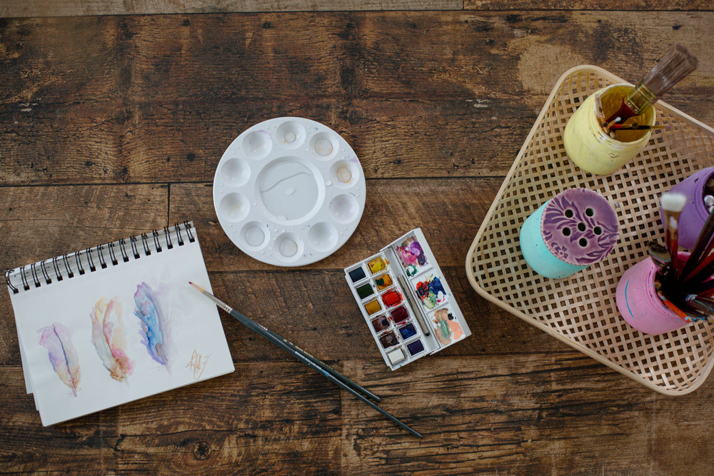 wooden craft table set up for watercolors