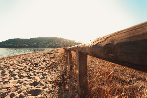 wooden fence on sandy beach