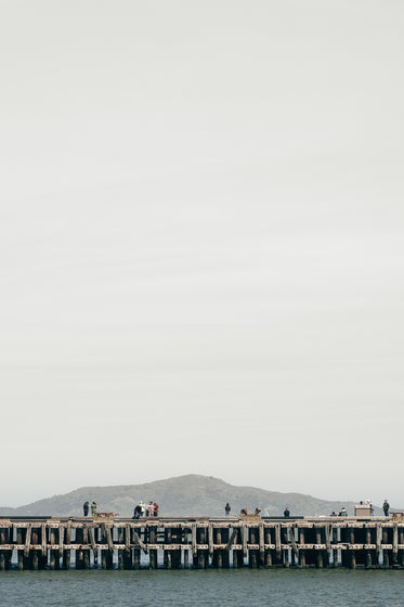 wooden pier under grey sky