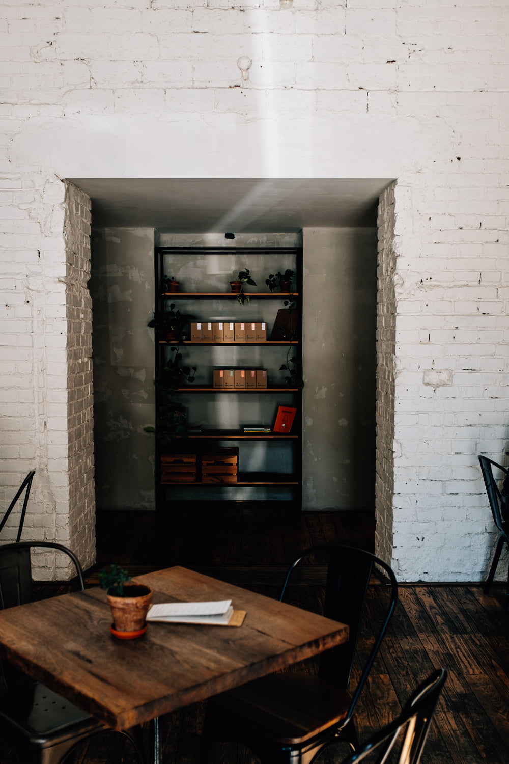 wooden table and stocked shelves