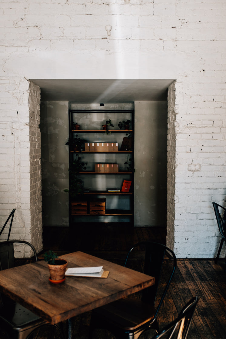 Wooden Table And Stocked Shelves