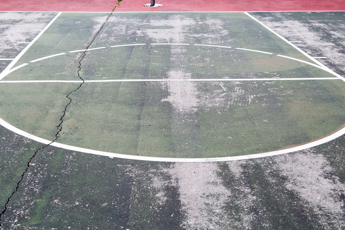 worn down outdoor basketball court