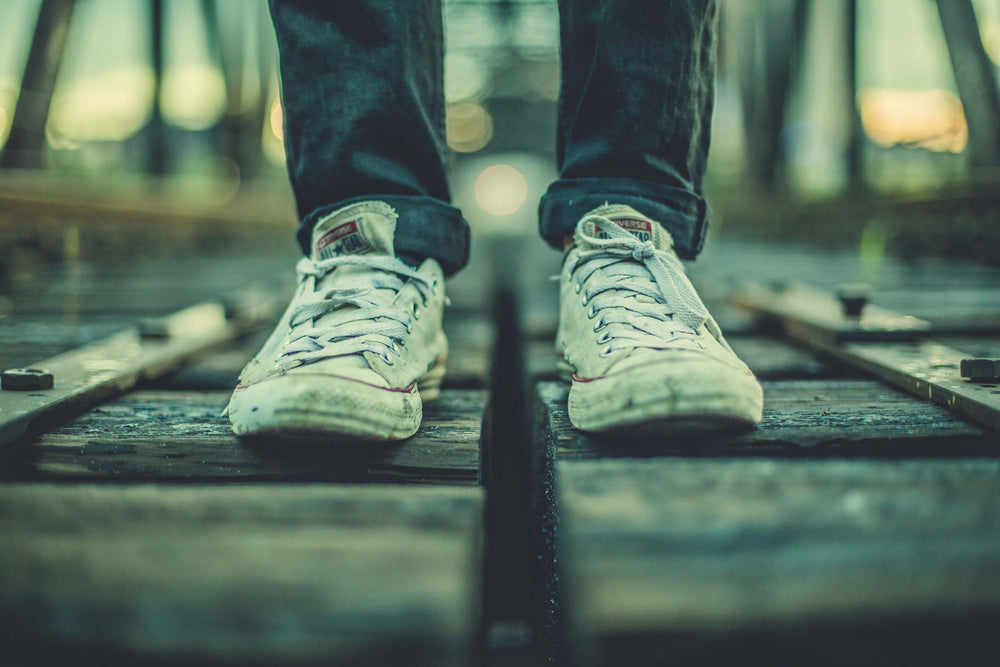 worn sneakers on tracks