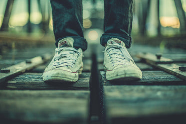 worn sneakers on tracks