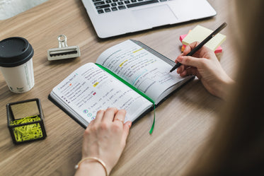 writing in notebook at desk