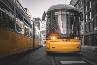 yellow and black streetcar stopped on tracks