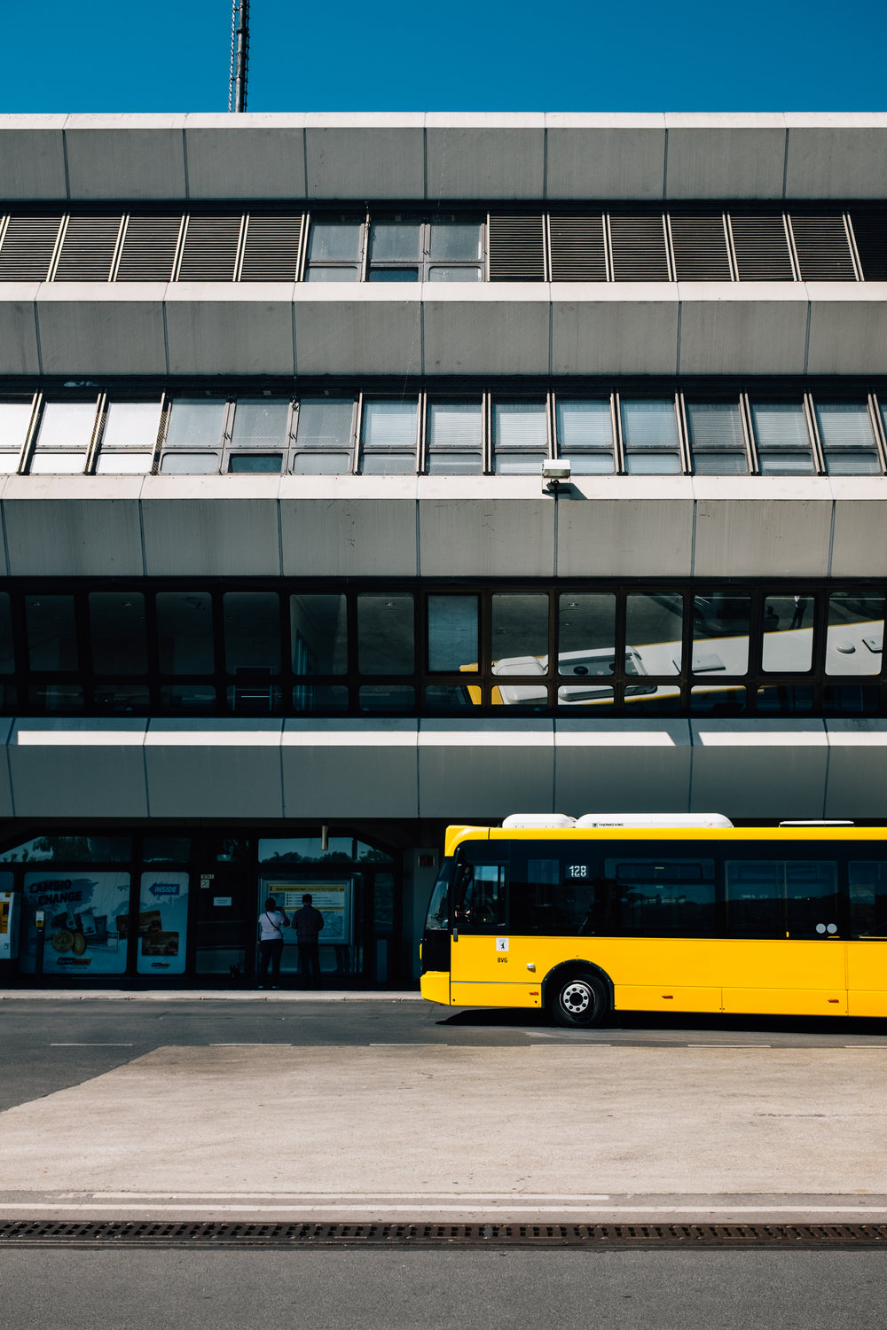 yellow bus parks in the big city