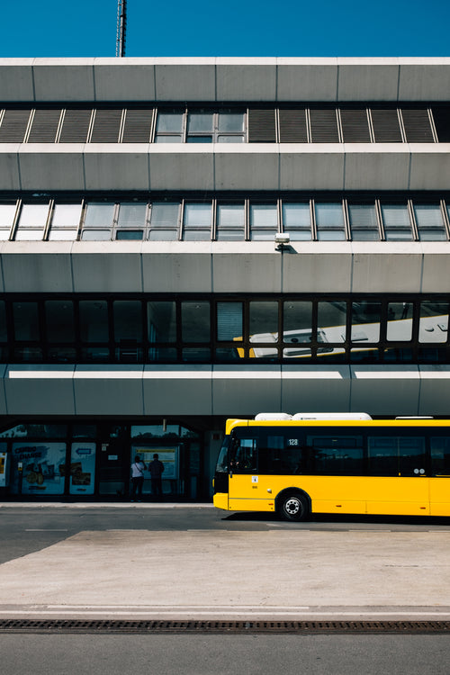 yellow bus parks in the big city