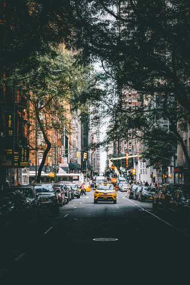 yellow cab drives through city