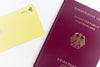 yellow card and a red and gold passport flatlay
