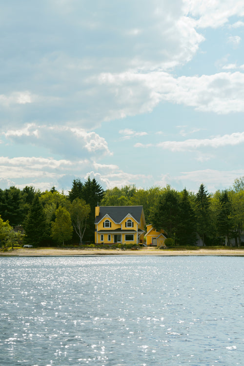 yellow cottage on lake