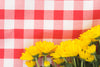 yellow flowers on picnic blanket